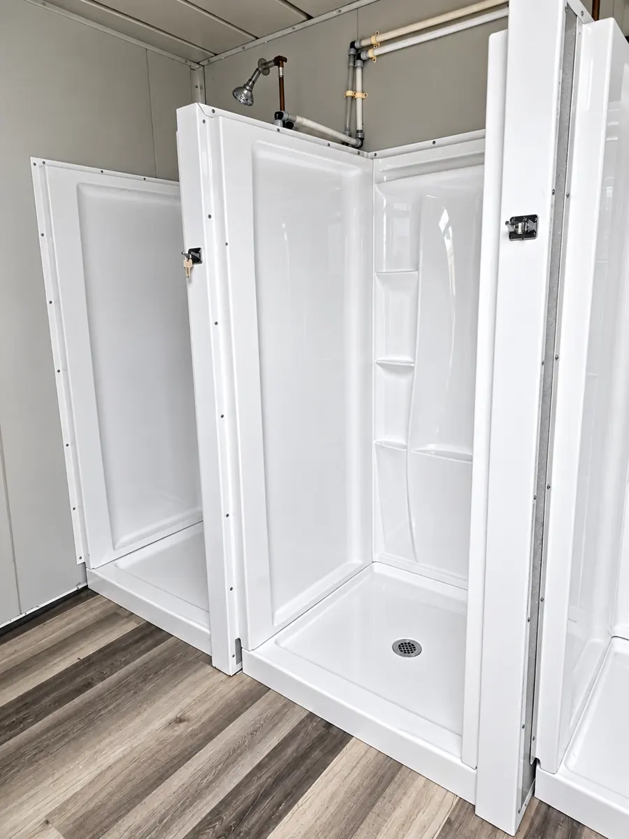 Row of private shower stalls inside a 20ft shower container